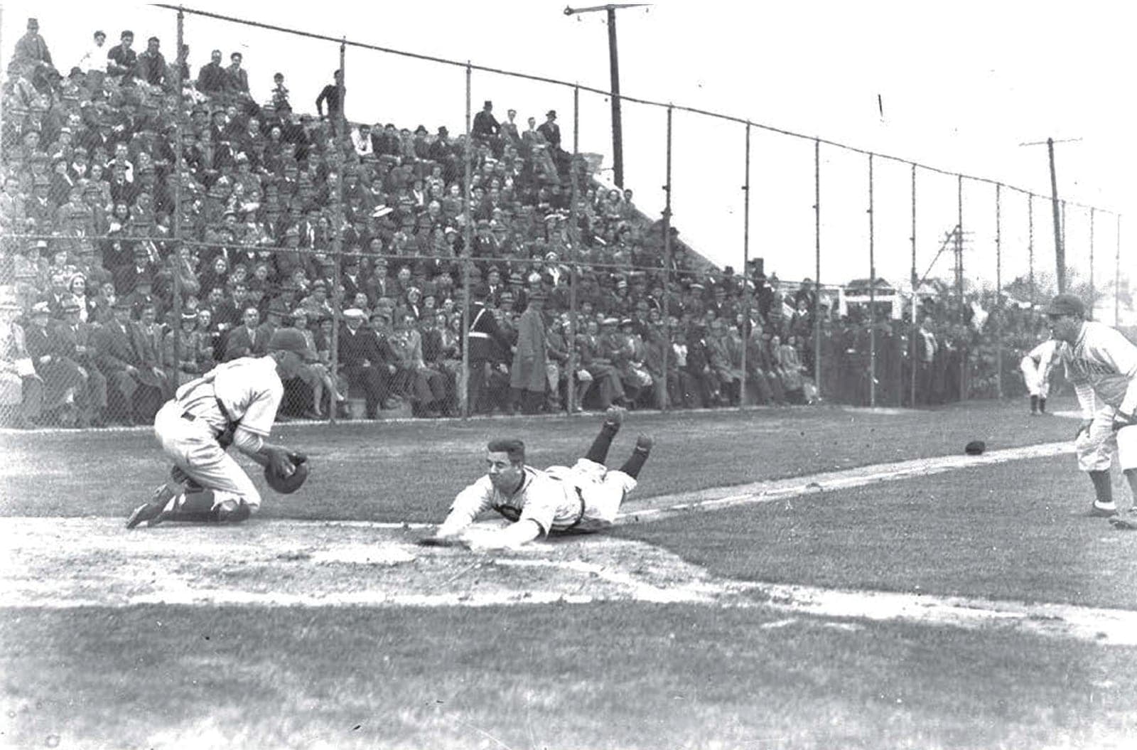 Black and white team photograph of the Fifth Ward baseball team in 1946, players in two rows in front of a fence